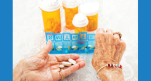 Elderly woman taking medication from pill box - AGS Beer Criteria